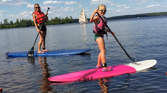 Mother and daughter paddleboarding on Lake Vermilion