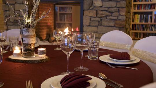 A winter table setting near the fireplace in the Main Lodge