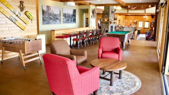 Pool table, foosball, and seating area in the main lodge.
