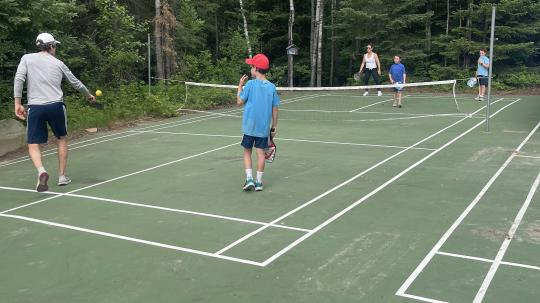 Family playing pickleball.