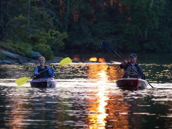 Couple kayaking at sunset