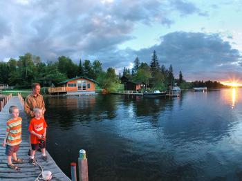 A family fishes from a dock at Pehrson Lodge