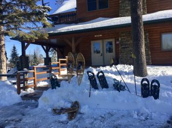 Lodge entrance in winter, with snow shoes stored in the snowbanks