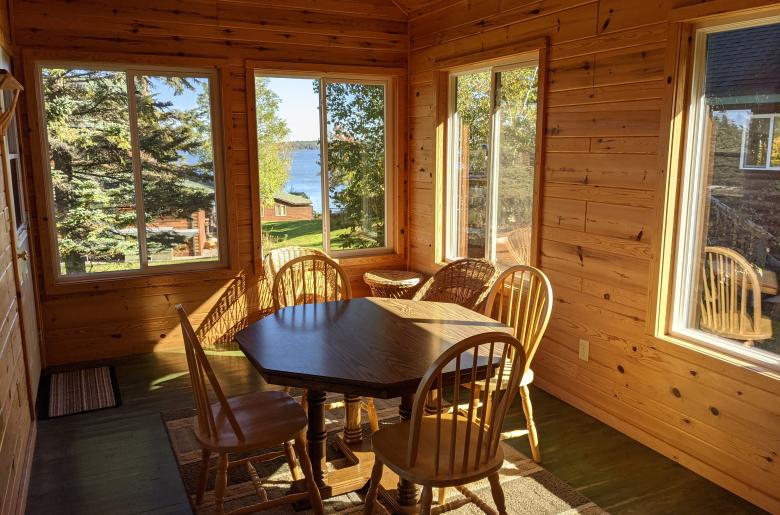 Three season porch area with seating and views of the lake.