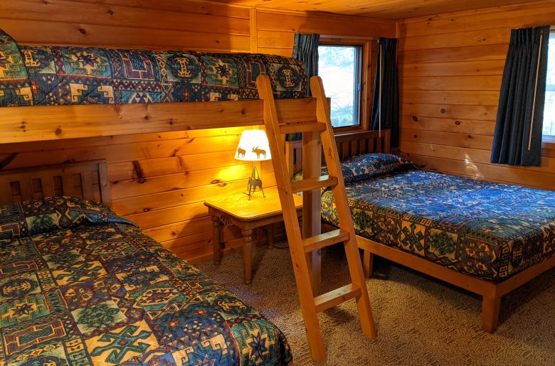 Bedroom with a full size bed, twin bed, lofted twin bed, and a ensuite bathroom.