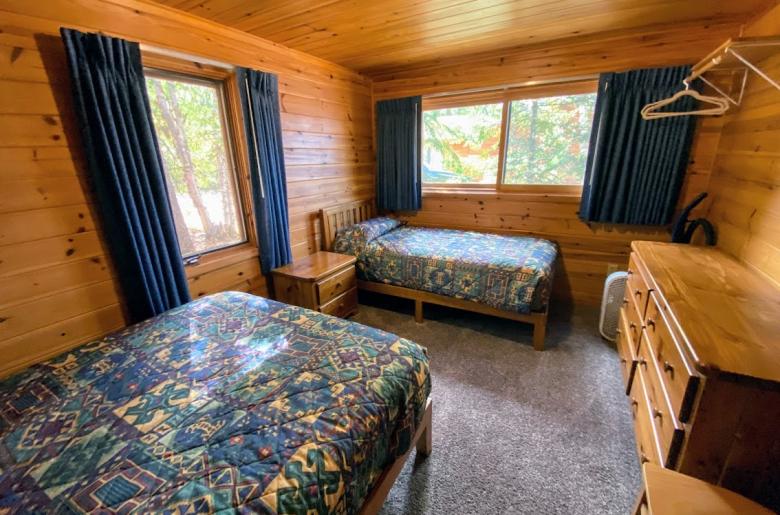 Bedroom with a full size bed and twin.