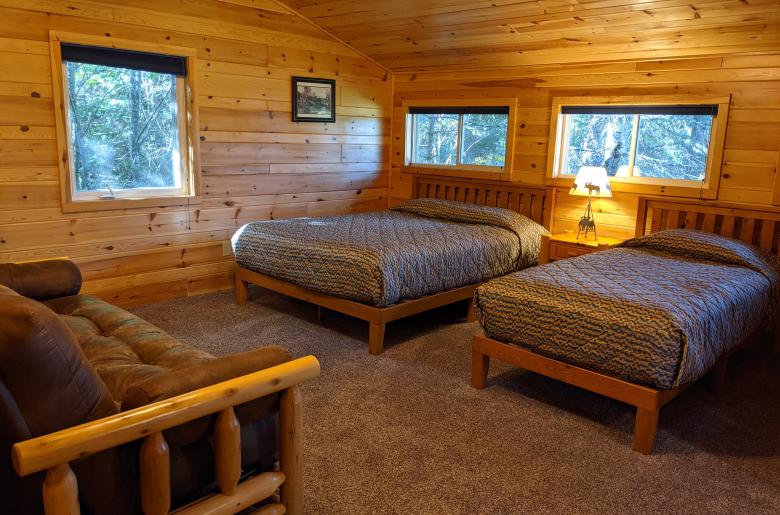 Upstairs bedroom with a queen, twin, futon, and ensuite bathroom.