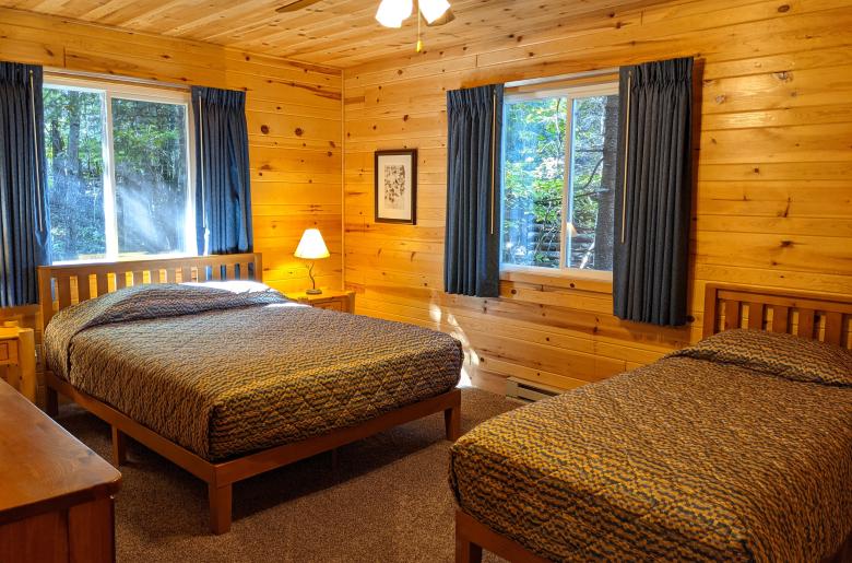 Main floor bedroom with a queen and twin bed.
