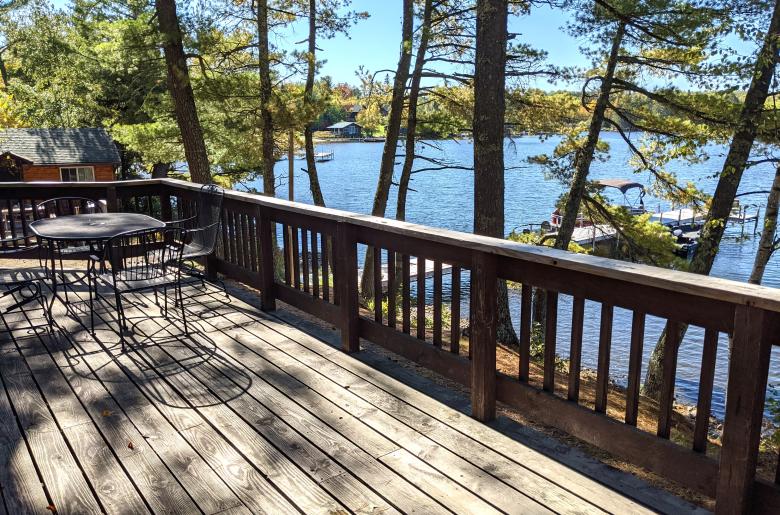 Deck area with picnic table, charcoal grill, and views of the lake.