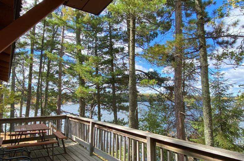 Deck area with a picnic table and charcoal grill.