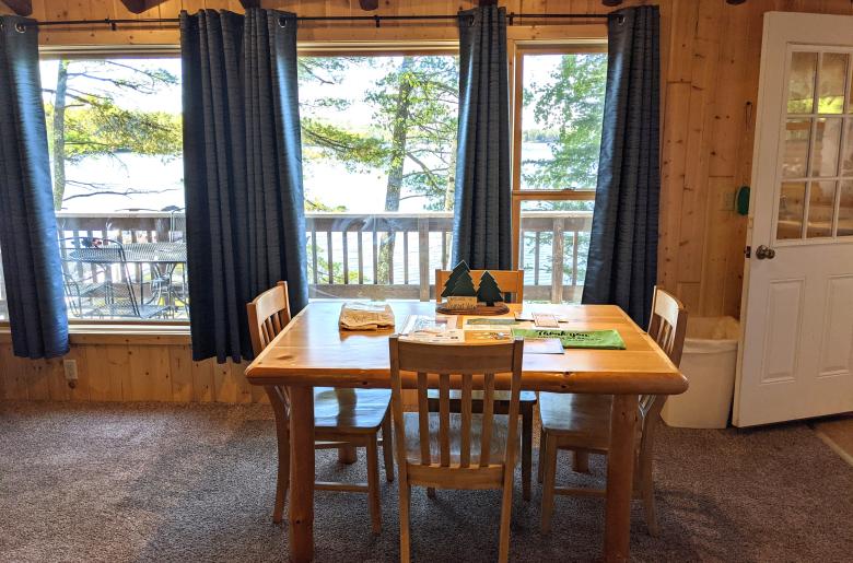 Dining area with seating and wood burning fireplace.