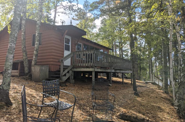 Exterior of Northern Lights, showing a lake facing deck and firepit.