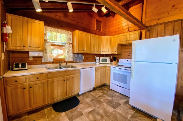Kitchen with a refrigerator, stove, and dishwasher.