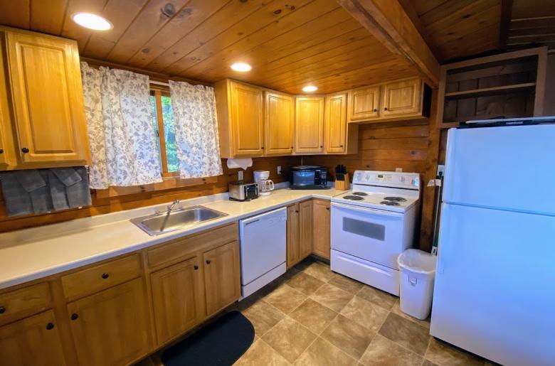 Kitchen with a refrigerator, stove, and dishwasher.