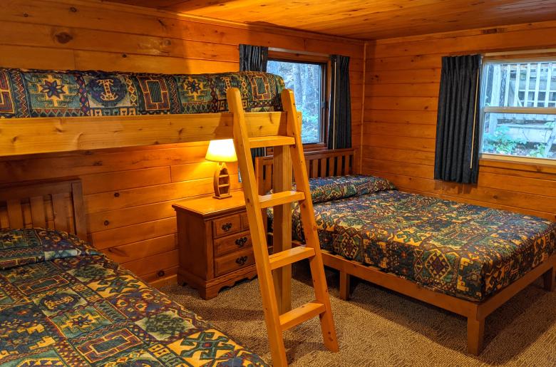 Bedroom with a full size bed, twin bed, lofted twin bed, and a ensuite bathroom.