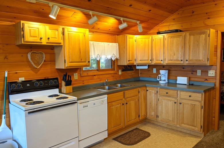 Kitchen with a refrigerator, stove, and dishwasher.