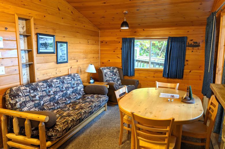 Living area with a futon, chair, and kitchen table.