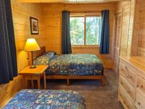 Bedroom with a full size bed and twin.