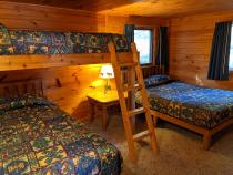 Bedroom with a full size bed, twin bed, lofted twin bed, and a ensuite bathroom.