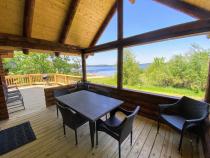 Covered porch area with seating and views of the beach.