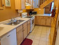 Kitchen with a refrigerator, stove, and dishwasher.