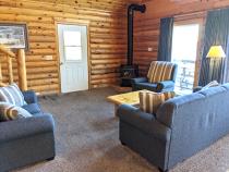 Living room with couch, loveseat, recliner, and gas fireplace.