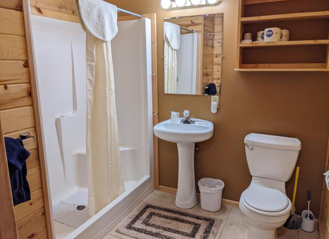 Main floor bathroom with wide door and easy access shower and sink.