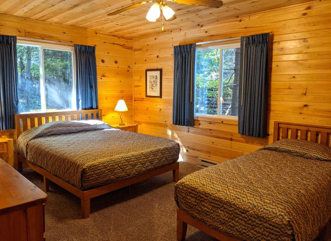 Main floor bedroom with a queen and twin bed.