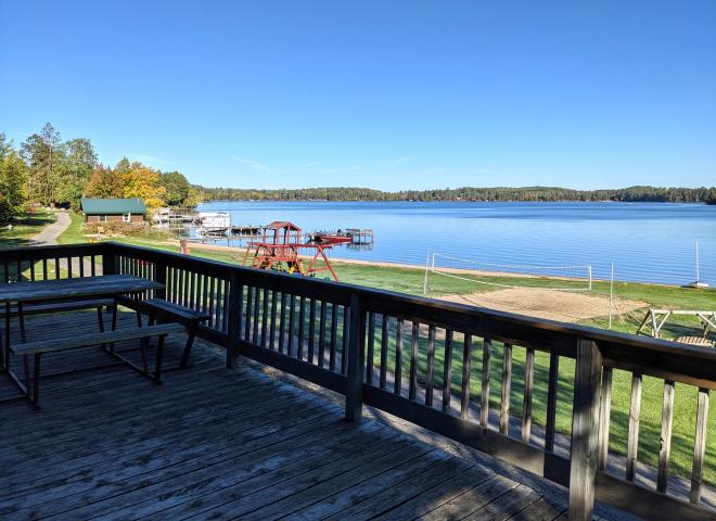 Deck overlooking the beach, with picnic table and charcoal grill.