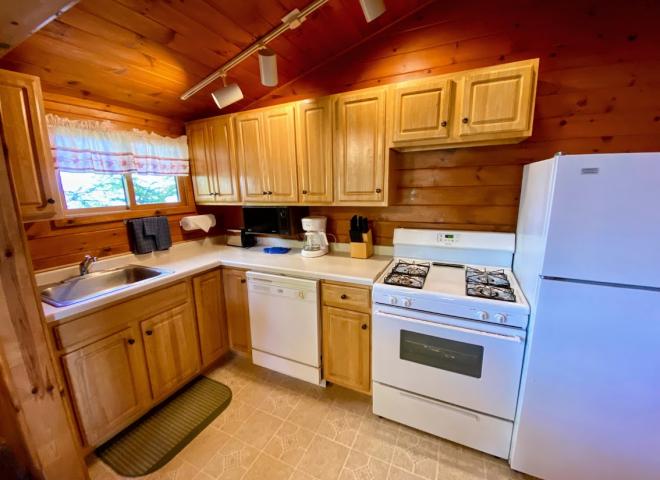 Kitchen with a standard refrigerator, stove, and dishwasher.