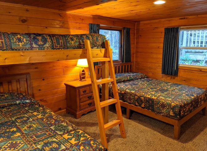 Bedroom with a full size bed, twin bed, lofted twin bed, and a ensuite bathroom.