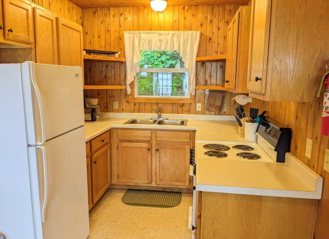 Kitchen with a refrigerator, stove, and dishwasher.