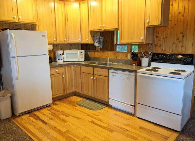 Kitchen with a refrigerator, stove, and dishwasher.