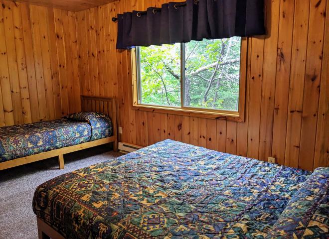 Upstairs bedroom with a queen and twin bed.