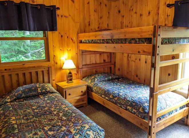 Upstairs bedroom with a twin and set of twin bunk beds.