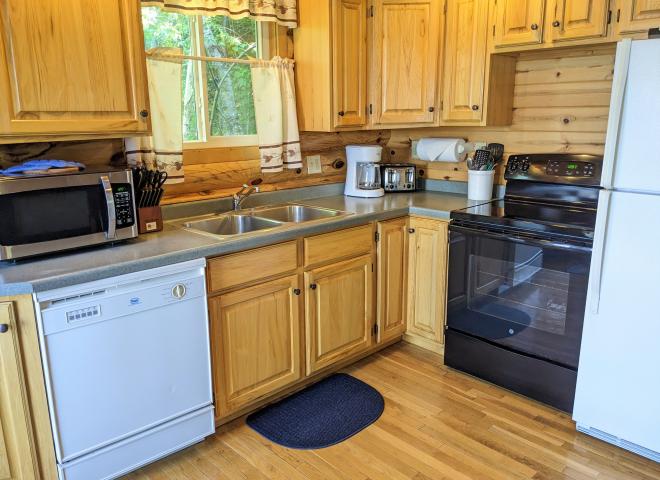Kitchen with a refrigerator, stove, and dishwasher.