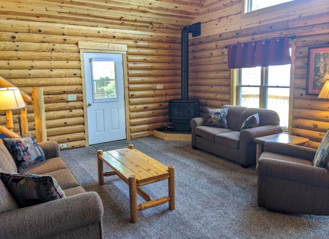 Living room with couch, loveseat, recliner, and gas fireplace.