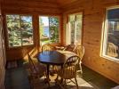 Three season porch with seating and lake views.