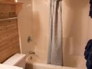Main floor standard bathroom with tub shower.