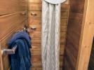 Small bathroom located in the upstairs with a shower stall.