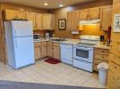 Kitchen with a standard refrigerator, stove and dishwasher.