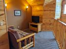 Loft area with futon, TV, and satellite programming.