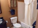 Upstairs bathroom with a standard tub shower.