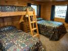Bedroom two with a double bed and twin bunk beds.