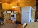 Kitchen with a standard refrigerator and stove.