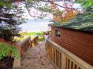 Side view of Lincoln, with a long deck walk way, overlooking the beach.