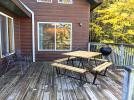 Deck area with a picnic table, grill, and views of Lake Vermilion.