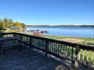 Deck area with a picnic table and grill overlooking the beach and Lake Vermilion.