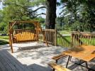 Deck area with picnic table, swinging bench and views of the lake.