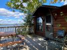 Deck with a picnic table, grill and lakeside views.